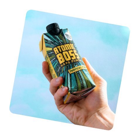 Image of Atomic Boss Tropical Fruit held in hand with sky background